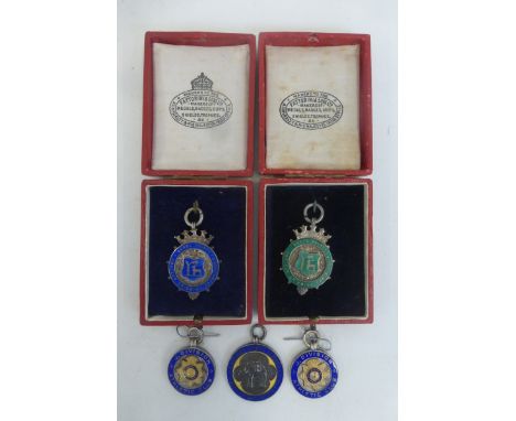 Five assorted silver and enamel medals, two 1930s for tug-of-war, two 1920s for swimming and a 1920s for gymnastics.