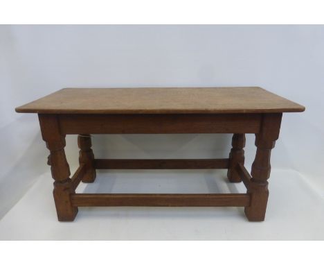 A Robert "Mouseman" Thompson 1957 oak coffee table with rectangular top on octagonal carved supports with plain stretchers, w