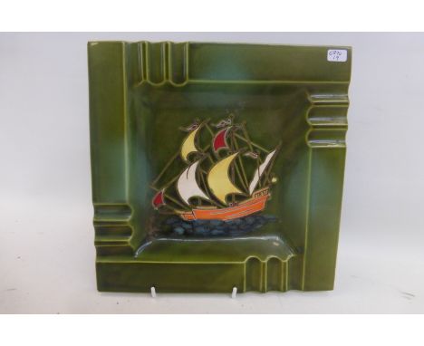 A ceramic and enameled ashtray depicting a galleon ship under sail, probably Danish.