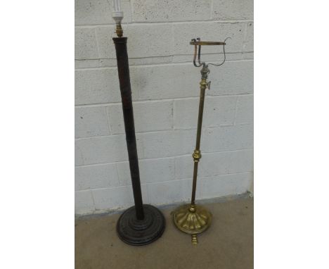 A carved wooden standard lamp and a brass extending standard lamp.