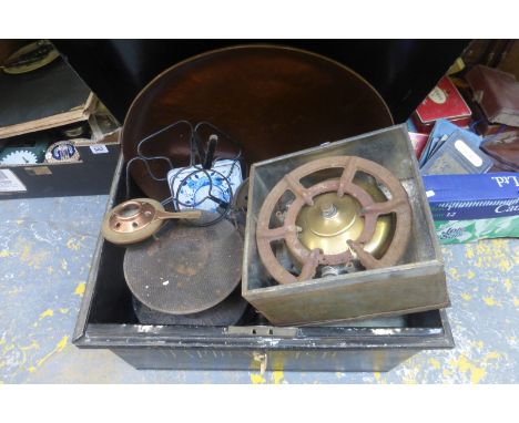 A tin trunk with an assortment of metal barrel taps, a copper tray, early primus stoves etc., the tin box marked "Hardenhuish