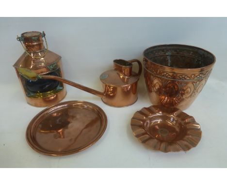 A Haws copper watering can, a copper tray and a J.S.&.S. Art Nouveau copper jardinière also a C.W.C. ship's starboard lantern