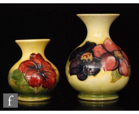 Two Moorcroft vases, the first decorated in the Clematis pattern with tubelined flowers against a yellow wash ground, impress