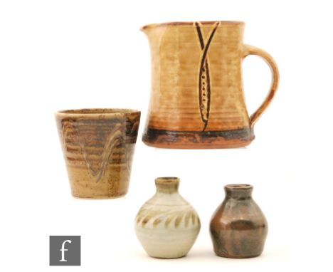 A Winchcombe studio pottery jug by Ray Finch of waisted cylindrical form with applied handle, slip decorated in brown against