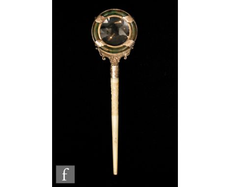 A Chinese green hardstone and silver mounted magnifier, circa 1900, the spinach jade roundel applied with lotus leaf silver m