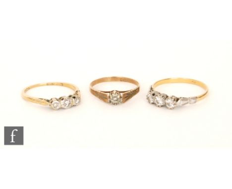 A mid 20th Century 18ct diamond three stone ring, with a similar illusion set example and a 9ct solitaire. (3).