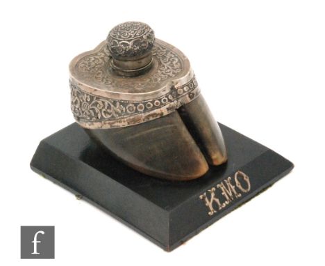 A 19th Century inkwell in the form of a horses hoof with Eastern white metal mount on an ebonised base initialled K.M.O, widt