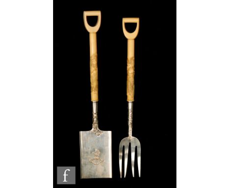 A pair of Japanese silver and ivory servers modelled as a spade and fork, the ivory handles detailed with monkeys falling to 