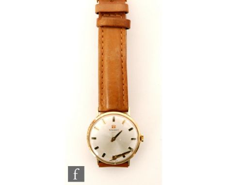 A 9ct hallmarked gentleman's Tissot wrist watch, batons to a circular silvered dial and tan leather strap.