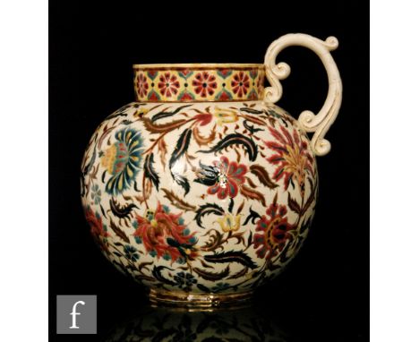 A Zsolnay Pecs jug decorated in the Persian taste of globular form with collar neck and scroll handle, decorated with stylise