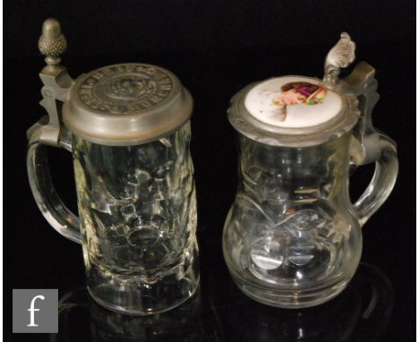 A 19th Century German clear crystal glass beer stein with cut decoration below pewter mounted cover with foliate thumb lift s