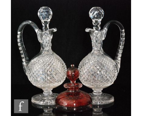 A pair of late 19th Century clear cut crystal decanters of footed globe and shaft form with strawberry diamond cut bodies, he