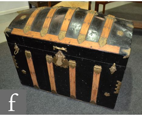 A late 19th Century leather domed cabin trunk with brass mounted and wooden strap work design and part fitted interior, width