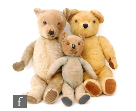 A group of three early 20th Century British teddy bears, including a blonde mohair example, straw filled with jointed limbs, 