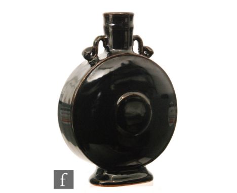 A Chinese mirror-glazed monochrome moonflask, the flattened rounded body rising from an archaic style foot, the knopped neck 
