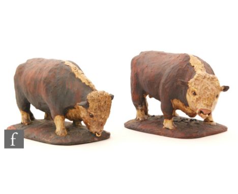 A pair of later 20th Century terracotta models of Hereford bull each with a gilt nose ring and stood on a rounded base, impre