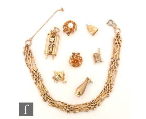 A 9ct rose gold gate bracelet with assorted charms and earrings, total weight 20g. S/D. 