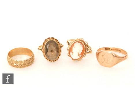Four assorted 9ct rings to include a cameo and a citrine example with a signet and a wedding ring, total weight 14g,. (4). 