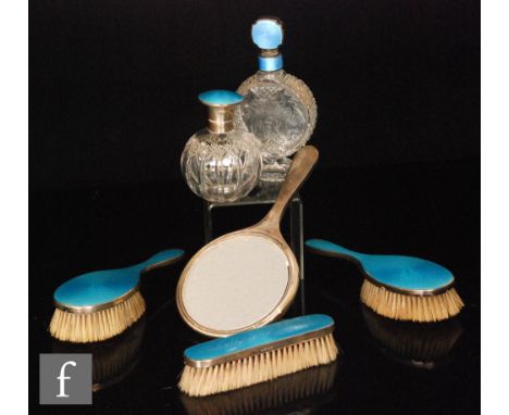 A hallmarked silver and blue gillouche enamel decoration backed brush set to include three brushes, hand mirror and a scent b