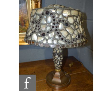 A table lamp in the Arts and Crafts style, possibly French, with a mother of pearl inset shade.