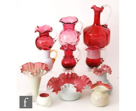 A group of six late 19th Century Stourbridge glass vases and other items all cased in opal over pink, including a trumpet for