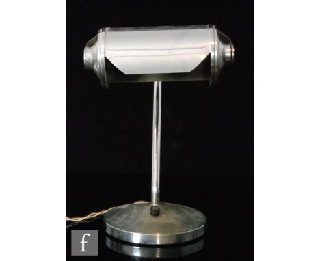 A 20th Century Art Deco chrome table lamp with cylindrical shade on a curved stand atop a circular base, height 31cm.
