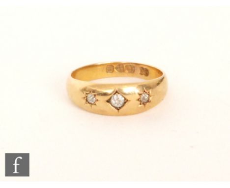 An early 20th Century 18ct hallmarked diamond three stone ring, gypsy set stones to a plain shank, Chester 1900