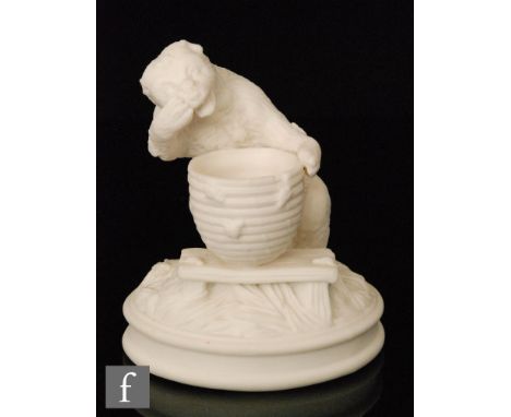 A 19th Century Parian vesta holder modelled as a bear stealing honey from an overturned beehive, all to a naturalistic base, 