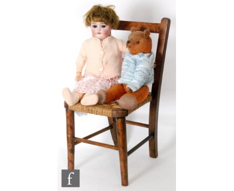 A late 19th or early 20th Century Simon and Halbig bisque head doll, with sleeping brown eyes, open mouth with teeth, pierced