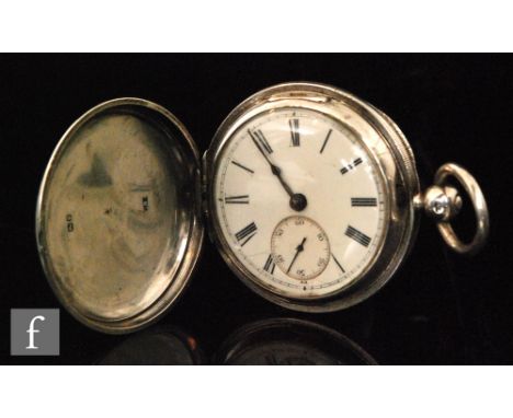 A Victorian hallmarked silver key wind full hunter pocket watch with white enamelled dial with Roman numerals and subsidiary 