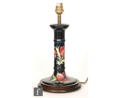 A Moorcroft table lamp decorated in the Anemone pattern, affixed to a wooden plinth, marks obscured, height 23cm