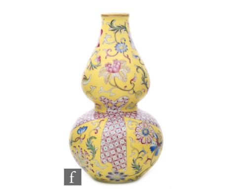 A Chinese famille rose double gourd vase, late Qing/Republic Period, the lemon yellow sgraffito ground delicately carved with