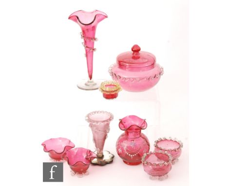 A collection of late Victorian ruby glass, including a posy vase of trumpet form with wide frill rim, clear crystal foot and 