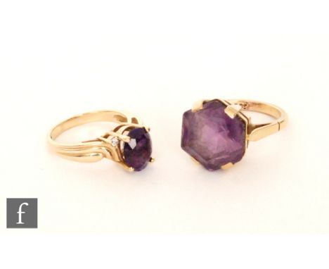 A modern 9ct hallmarked amethyst single stone ring, claw set oval stone to reeded shoulders, with a similar example stamped 9