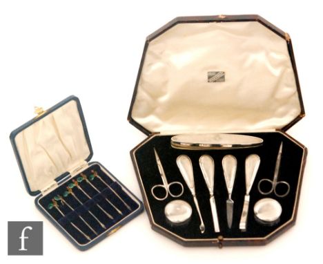 An Art Deco hallmarked silver eight piece manicure set with engine turned decoration, with a cased set of six hallmarked silv
