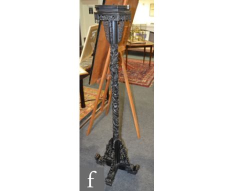 A contemporary Chinese standard lamp in an ebonised finish, the octagonal shaped top above a pierced frieze, all above a drag