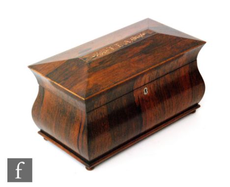 A large 19th Century inlaid mahogany tea caddy of bombe shape with marquetry named detail to the cove Tea, opening to reveal 