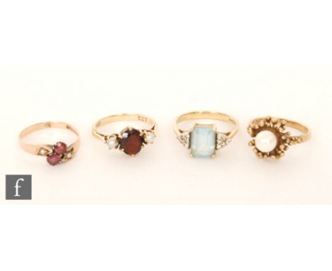 Four 9ct stone set rings to include blue topaz, amethyst and garnet examples, total weight 10g, various styles and dates. (4)