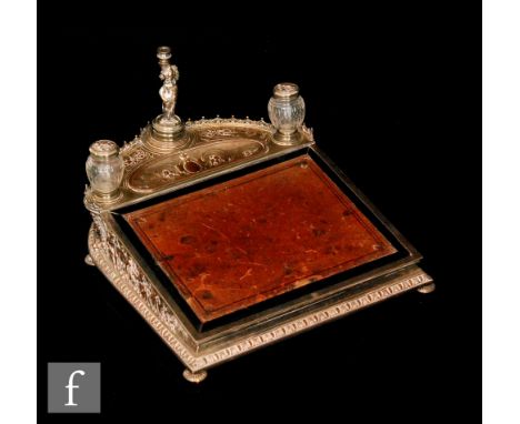 A late 19th Century silver plated writing slope, the hinged leather front panel opening to a padded blue silk lined interior 