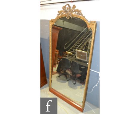 A large 19th Century gilt framed pier mirror, the arch top mounted with a quiver, torch and a cornucopia of flowers above a d