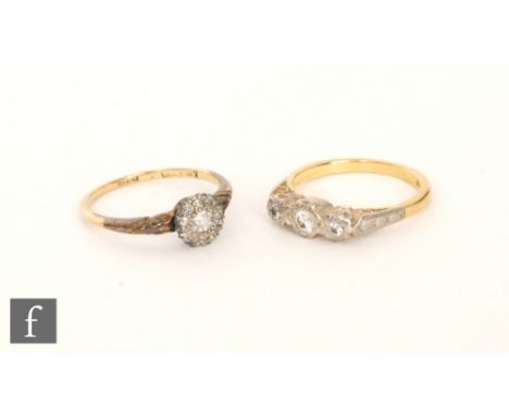 An 18ct diamond cluster ring central old cut stones within an eight stone surround, with a similar 18ct diamond three stone r