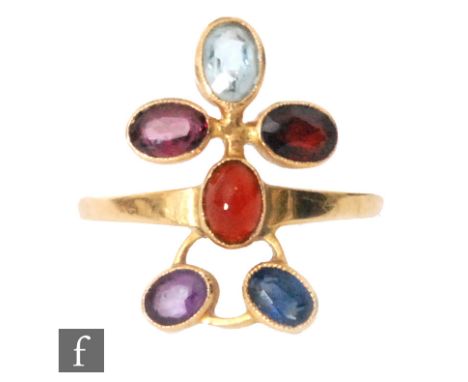 An 18ct hallmarked multi stone ring modelled as an abstract standing figure set with aquamarine, sapphire, garnet, amethyst e