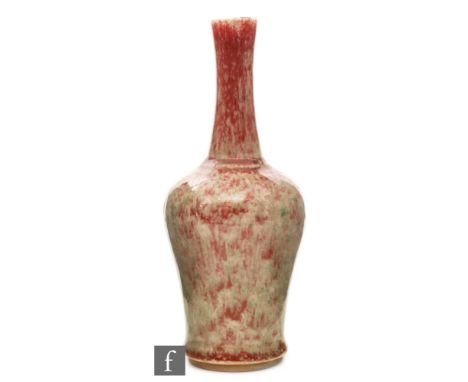 A Chinese 'Peach Bloom' glazed bottle form vase with tapered shaft neck, red green and white blushing variegated glaze, inter