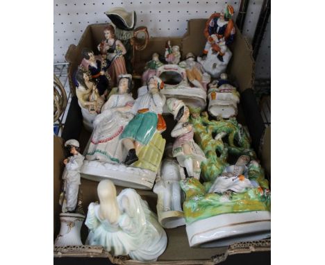 A box containing a selection of ceramic figurines to include Staffordshire