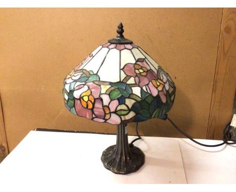 A Tiffany style table lamp with coloured glass floral shade, on naturalistic base (42cm)