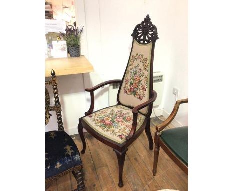 An Edwardian mahogany open armchair, the high back with intricately pierced crest above a tapestry upholstered back and seat 