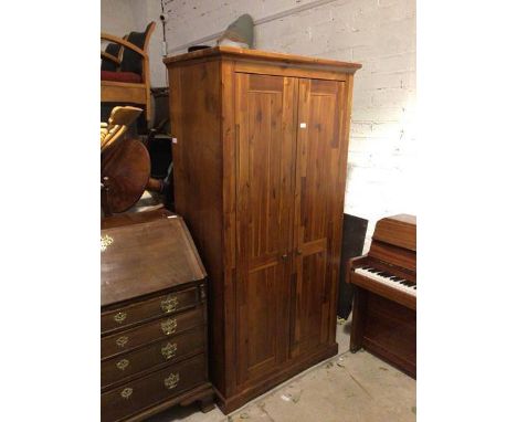 A Morris Furniture &amp; Co. wardrobe, the moulded cornice above two panel doors, with shelved interior, fitted for hanging, 