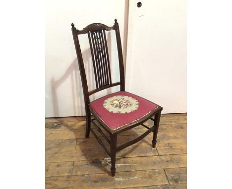 An Edwardian mahogany bedroom chair, with fan surmount to top rail above a pierced splat with tapestry seat, on straight tape