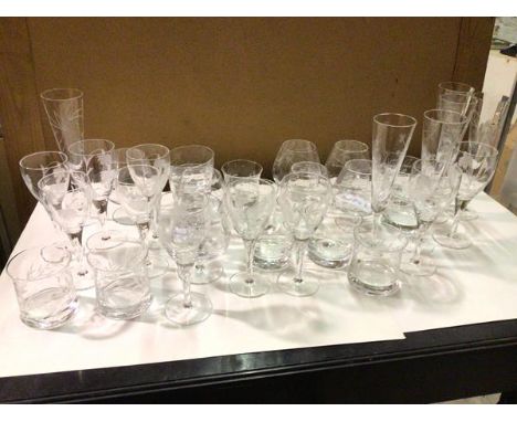 A large collection of glassware, all etched with foliate decoration, including six champagne flutes (24cm), brandy goblets, w