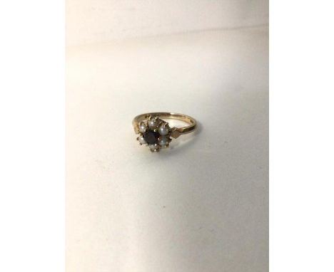 A 9ct gold cluster ring with garnet surrounded by pearls (M) (2.5g)